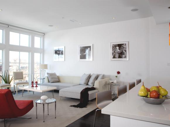 White Living Room with Gray Sectional and Red Chair