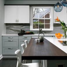 Monochromatic Kitchen with Blue Pendant Lighting