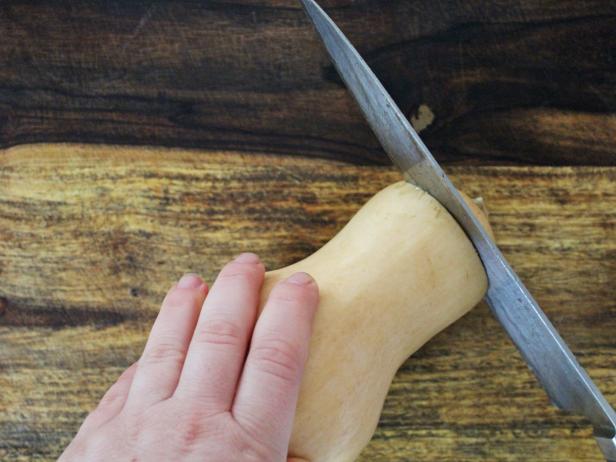 In step one of this project, use a sharp knife to cut the top off of the squash.