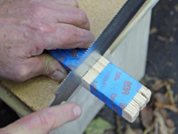 Using a speed square or ruler, measure out the desired length and mark with a pencil. On a flat, secure surface, cut the group of sticks to desired length. Repeat with a second group of taped sticks.