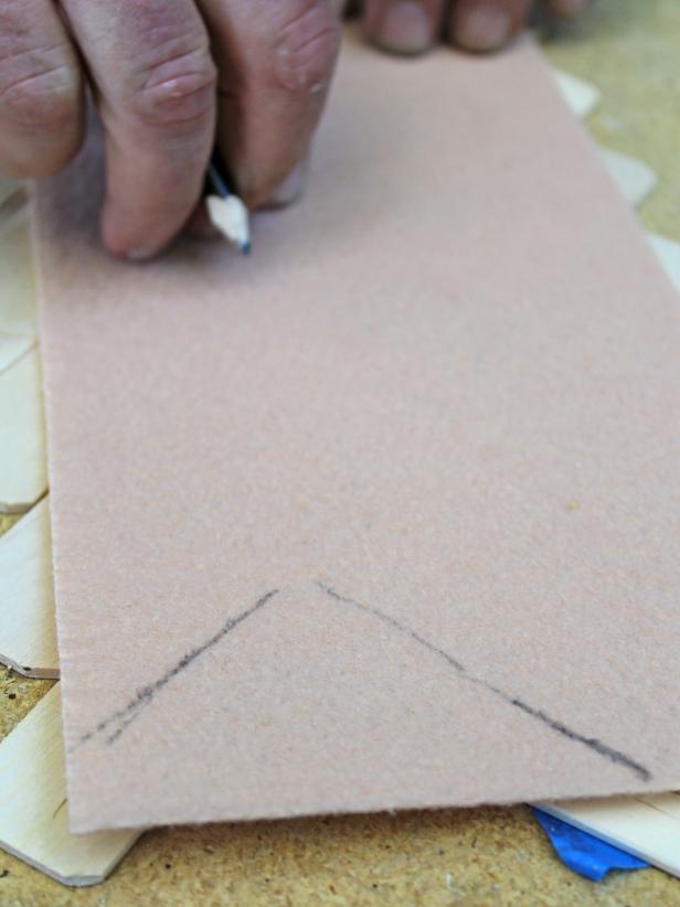 Using a utility knife, cut a piece of felt to the rough width of the runner. Then, use a pencil to mark where additional cuts should be made to ensure felt isn't visible from top of runner. Make additional cuts with utility knife.