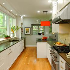 Contemporary Galley Kitchen With Sleek Cabinetry and Orange Pendant