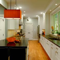 Contemporary Galley Kitchen With Orange Pendant Light 