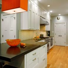 Blue Contemporary Galley Kitchen With White Cabinets and Orange Pendant Light