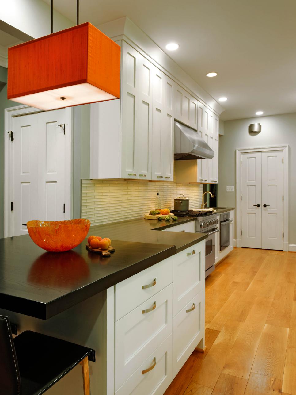 Blue Contemporary Galley Kitchen With White Cabinets and Orange Pendant