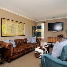 Masculine Living Room With Leather Sofa and Cowhide Ottomans