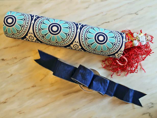 Fill the fabric covered cardboard tube with one large or several small gifts.