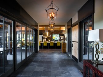 Wide Foyer With Slate Floor and Glass Urn Pendants
