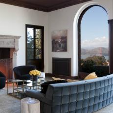 White Living Room With Arched Window Boasts Mountain Views
