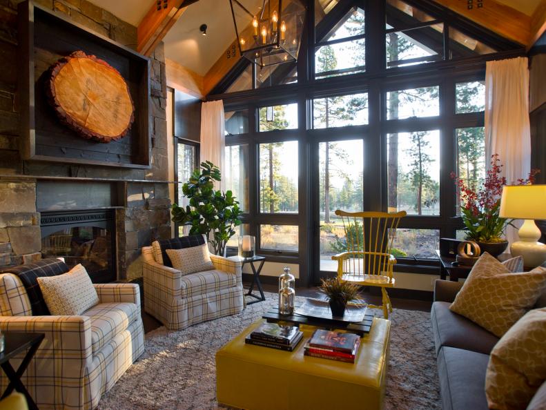 Rustic Living Room With Plaid Chairs, Yellow Ottoman & Stone Fireplace