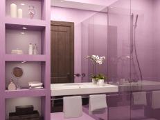 Interior view of Purple tiled bathroom with all glass shower.