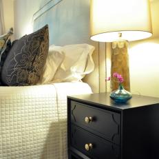 Bedroom's Black Side Table Contrasts Neutral Bedding