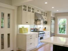 White Transitional Kitchen With Craftsman Cabinetry and White Sliding Door