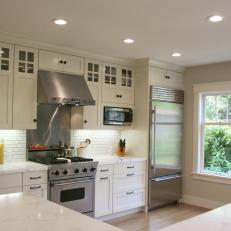 Airy, Transitional Kitchen With White Subway Tiles and White Marble Countertops