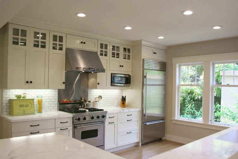 Airy, Transitional Kitchen With White Subway Tiles and White Marble Countertops Transitional Kitchen With White Subway Tiles and Marble Countertops