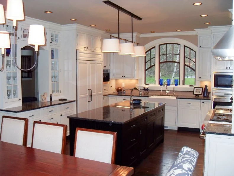 Transitional Eat-In Kitchen With Arched Windows Neutral Kitchen With Black Island, White Cabinets and Arched Windows