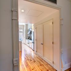 Detailed Alcove Provides Passageway Between Living Room and Kitchen