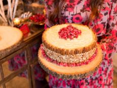 This decadent, cardamom-scented cake features a colorful surprise inside: cranberry-orange filling. A light-as-air maple frosting, sugared cranberries and a pecan garnish make this cake fit for a celebration.