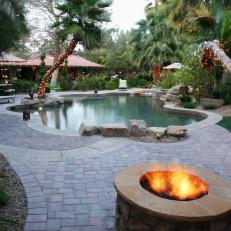 Tropical Pool With Lush Landscaping and Stone Tile