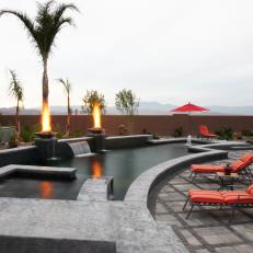 Modern Pool With Waterfall and Fire Pits