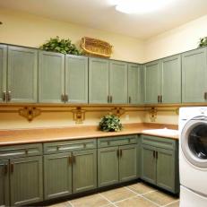 Spacious Laundry Room With Green Cabinetry