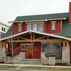 Red Craftsman-Style Home With Stone Wall