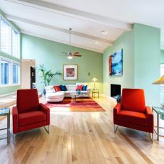 Pastel Green Living Room With Red Armchairs
