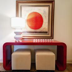 Entryway With Red Console Table and Tan Ottomans
