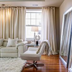 Transitional Beige Living Room With Patterned Accents and Floor-Length Curtains