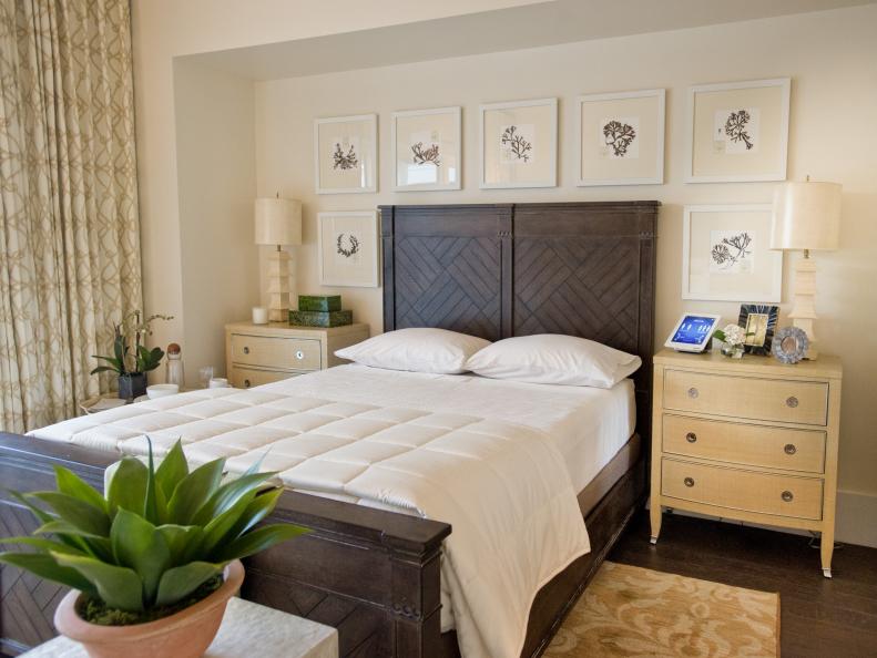 White Room With Dark Wood Headboard, Box-Stitched Quilt and Framed Art