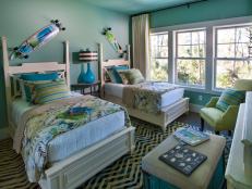 Fun and youthful, the home's second guest bedroom celebrates life at the beach with artwork inspired by location, tropical-print fabrics and a color palette drawn from sea shades.