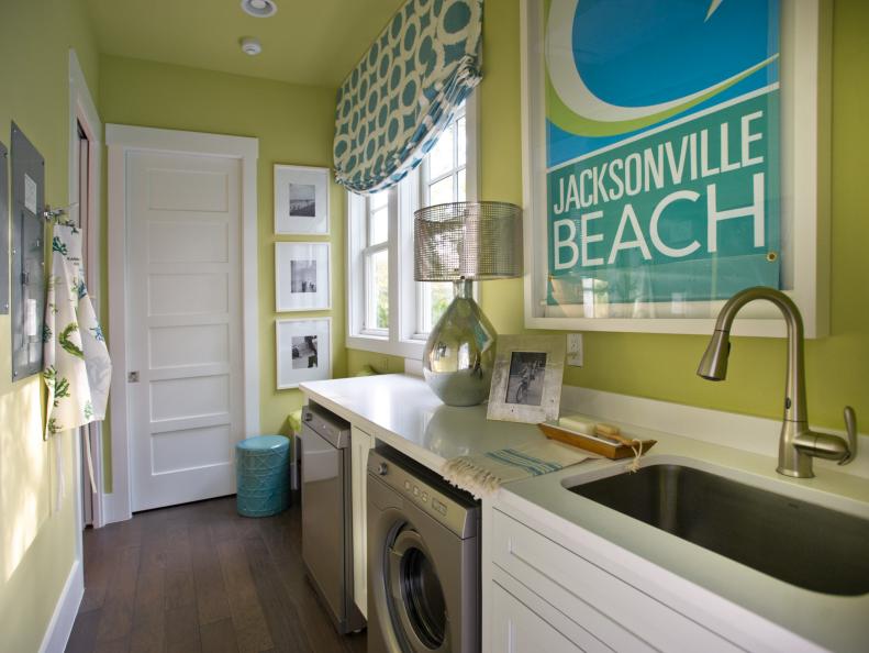 Green Laundry Room With Blue and White Roman Shade and a White Countertop