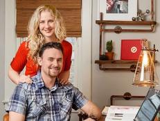 Happy homeowners in a redesigned study room with eclectic furnishings.