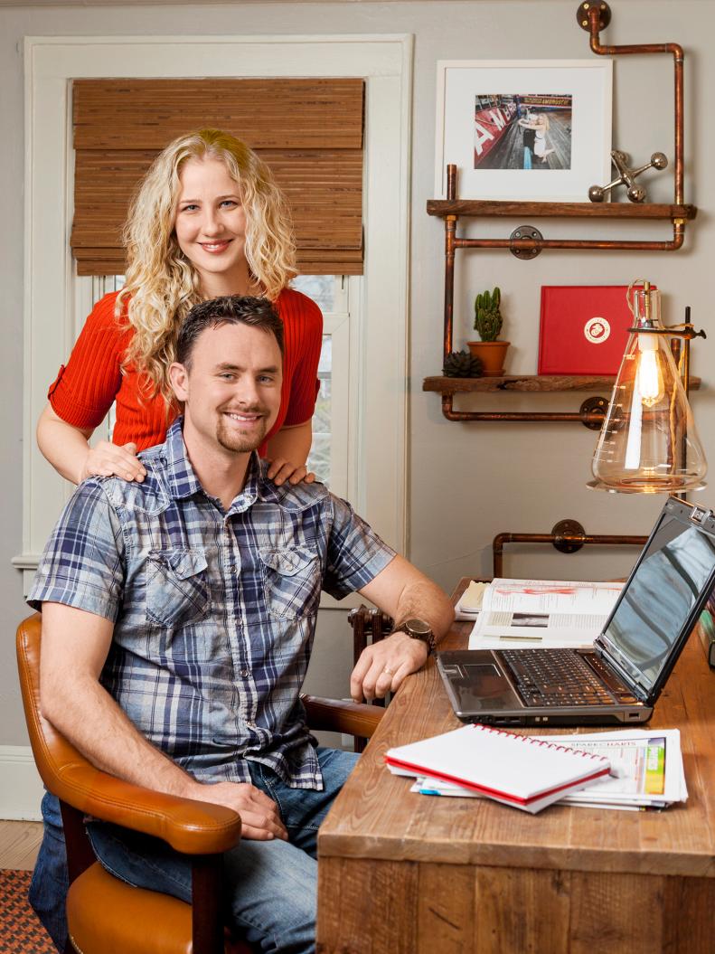 Happy homeowners in a redesigned study room with eclectic furnishings.