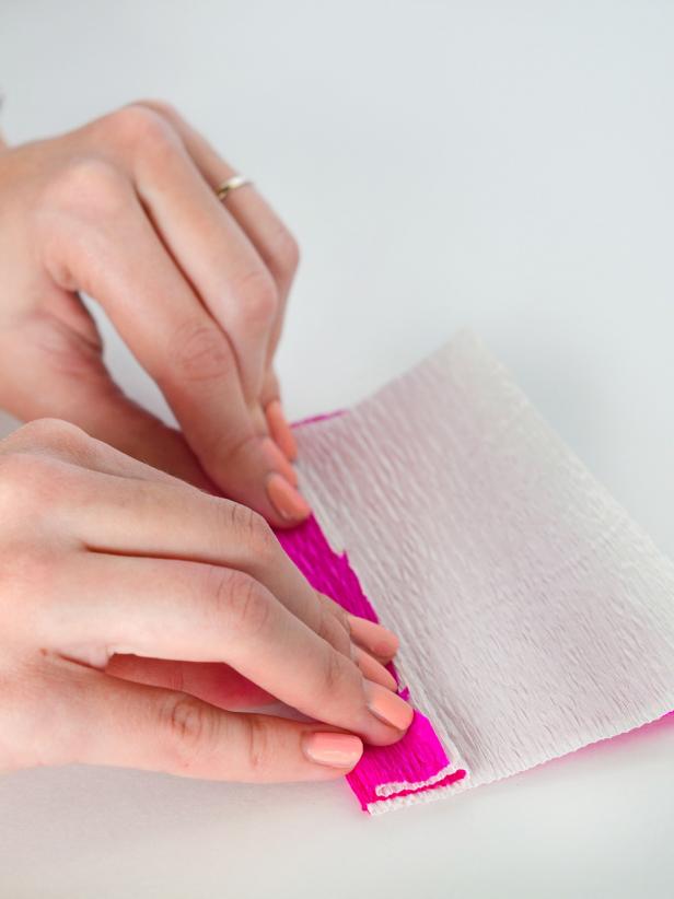 Place white square on top of pink square and fold the paper back and forth accordion-style.
