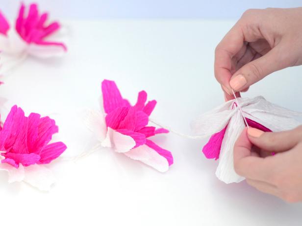 Repeat preceding steps to create five flowers then attach them to a long strand of kitchen twine. Tie both ends of twine together to form a circular lei.