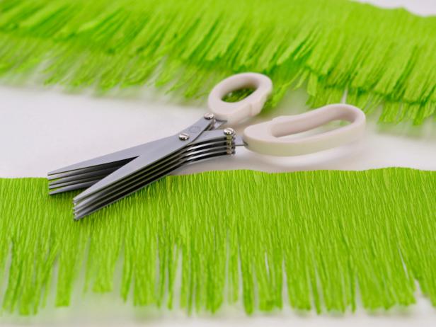 Use fringe scissors to create fringe down one side of all crepe paper strips.