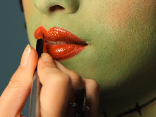 To turn your tween into a hip Frankenstein for Halloween, cover the entire face with green cream makeup. Define brows with a makeup pencil, and cover lids in mauve eyeshadow. Add liner and mascara for older girls. On one cheek, draw a short line with black liner under eye, angling down toward the jawbone. Shade under line with a touch of mauve or purple eyeshadow to make it appear three-dimensional. Next, use black liner to draw vertical stitch lines or, for a super-easy way to make the detail appear more realistic, glue little pieces of black yarn across the drawn line using eyelash glue. Continue stitch effect across the neck using black liner. Shade around stitch effect on neck with a touch of mauve or purple eye shadow to make it appear three-dimensional. Line lips and fill in with red liner. Using a rich red lipstick, coat lips. Add 3-D prosthetic bolts with liquid latex or spirit gum, and attach black and white wig.