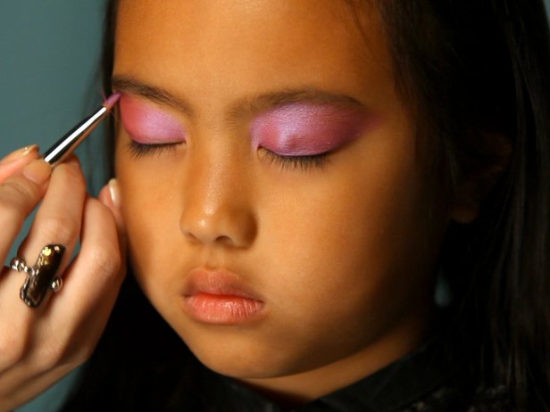 To apply fairy princess makeup, begin by painting eyelids with a pearly shade of eye shadow. Use a wet eye shadow for this, or shimmering face paint. Tip: Paint all the way up to eyebrows so the color is easily seen. Using a sponge or finger, blend a lighter shade of pearly eye shadow over and above eyebrows. Brush pink blush on apples of cheeks, continuing up to the highest point of cheekbones.
