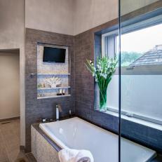 Neutral Bathroom With Soaking Tub and TV