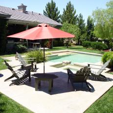 Backyard Pool With Adirondack Chairs and Red Umbrella 