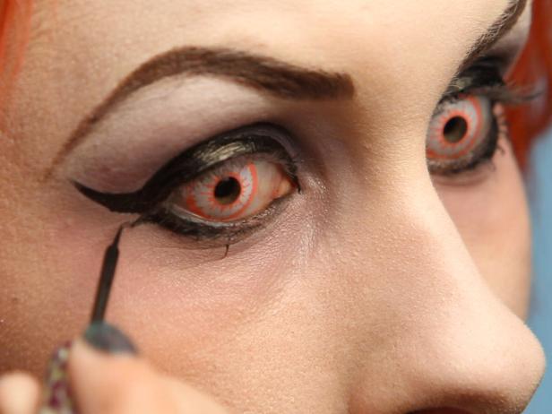 Add liquid liner underneath the eye, and coat top and bottom lashes with a thick coat of black mascara.