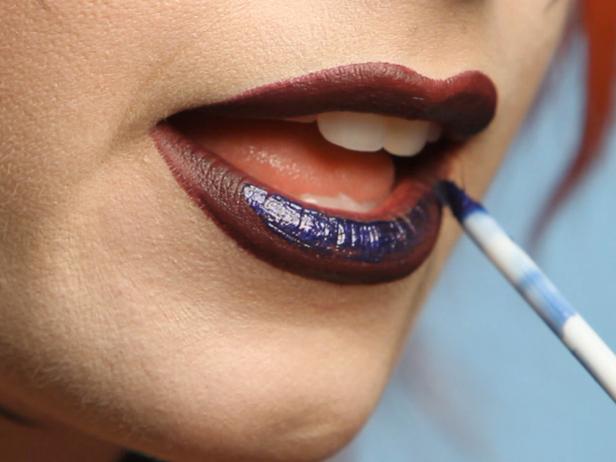 For some extra va-va-voom, top your dramatic purple lipstick with some with dark blue lip gloss.