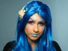 Woman Dressed as Mermaid With Blue Wig, Scales and Faux Pearls