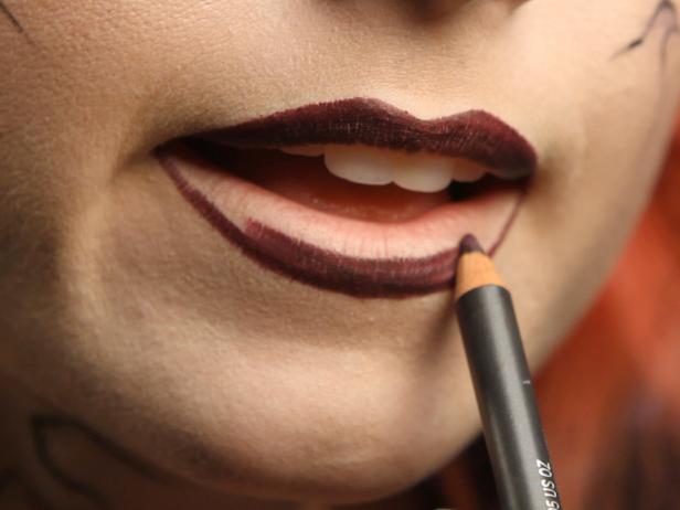 Apply dark purple liner to fill in lips. Add dark purple lipstick on top of the liner. Using liner under your lipstick will help define your lips and make your color last much longer.