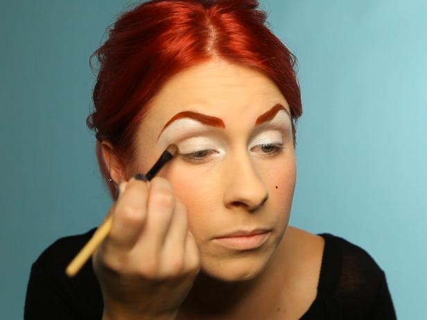 Add a light brown eye shadow to the outside corner of lids.