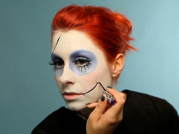 Next, draw two &quot;Joker&quot;-style lines coming from the corners of your mouth going up the cheeks. If you used cream makeup, set it with powder before moving on.
