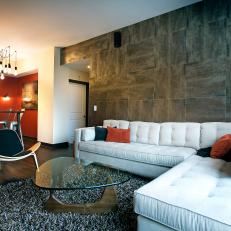 Contemporary Living Room With White Sectional Sofa and Gray Tile Wall
