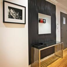 Contemporary Entryway With Ebony Accent Wall and Modern Art