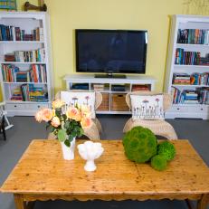Yellow Country Living Room With White Bookshelves